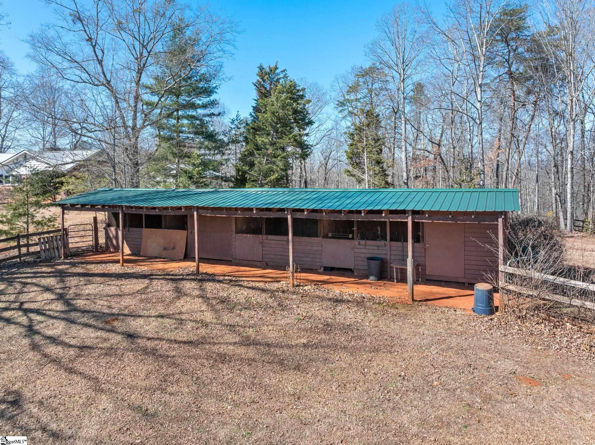 405 Loop Road Campobello, SC 29322 - Photo 7 of 49 3 stalls plus a Feed/Tack Room. Covered area on the back of the barn offers a storage area for equipment and/or hay