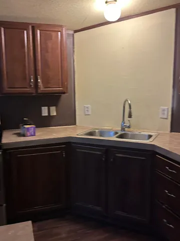 a sink with wooden cabinets