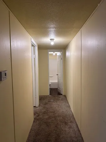 a view of hallway with an empty room