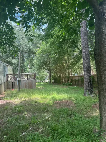 a backyard of a house with lots of green space and chair