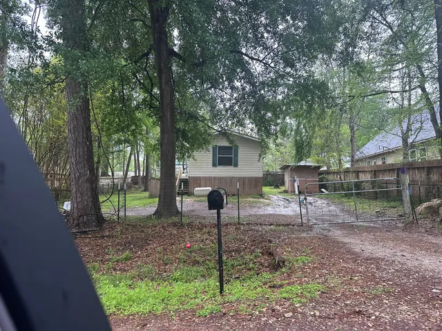 a backyard of a house with table and chairs