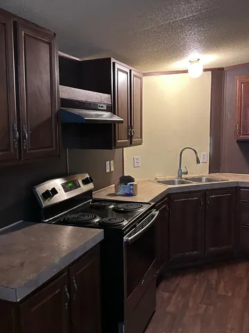 a kitchen with a sink stove and microwave