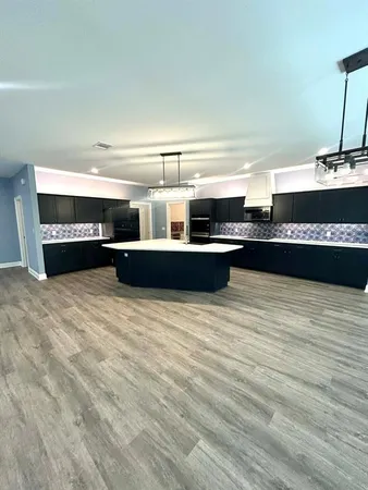 a view of kitchen and empty room