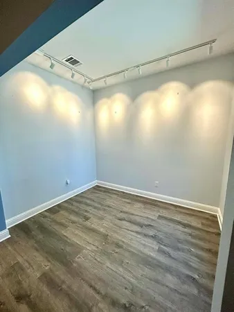 a view of a room with wooden floor and windows