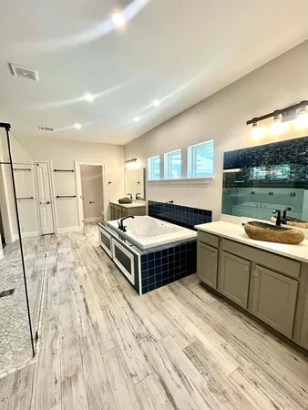 a spacious bathroom with a double vanity sink and a large mirror