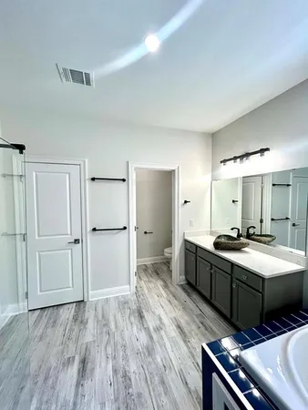 a room with a bed and a dresser
