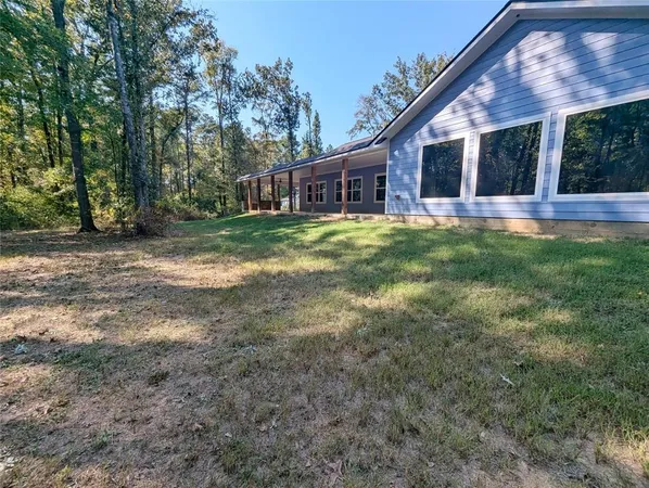 a view of a house with yard and tree s