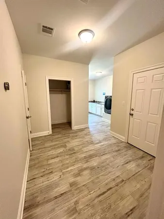 a view of a livingroom with wooden floor and stairs