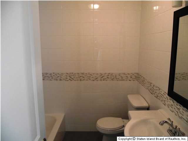 29 Midland Road Staten Island, NY 10308 - Photo 13 of 20 a white toilet sitting next to a shower