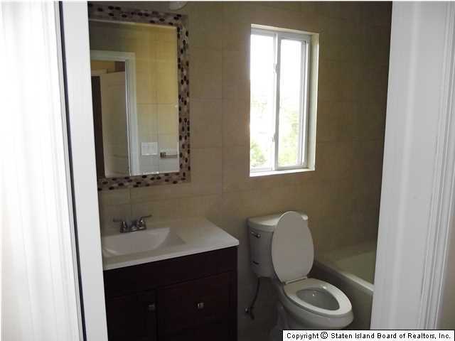 29 Midland Road Staten Island, NY 10308 - Photo 14 of 20 a bathroom with a toilet a sink and mirror
