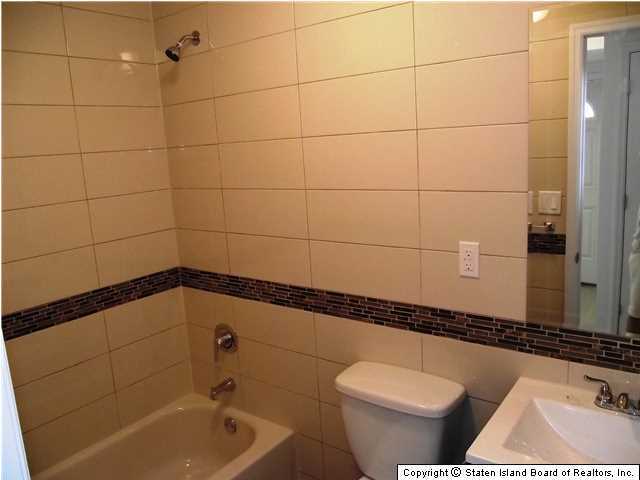 29 Midland Road Staten Island, NY 10308 - Photo 18 of 20 a bathroom with a toilet and a bathtub