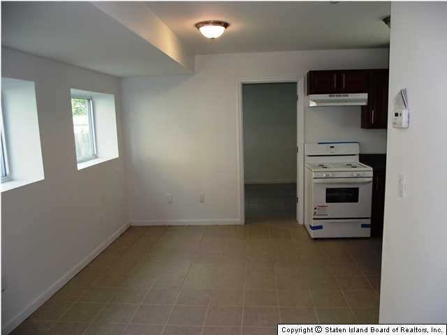 29 Midland Road Staten Island, NY 10308 - Photo 19 of 20 a kitchen with a stove and a refrigerator
