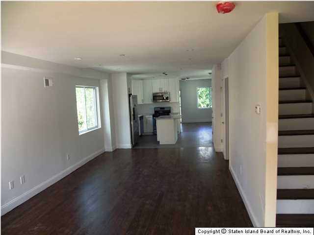 29 Midland Road Staten Island, NY 10308 - Photo 2 of 20 a view of a hallway with wooden floor fireplace and windows