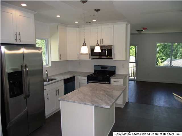 29 Midland Road Staten Island, NY 10308 - Photo 4 of 20 a kitchen with kitchen island a counter space a sink appliances and cabinets