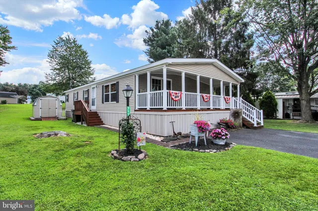 a front view of a house with a yard table and chairs