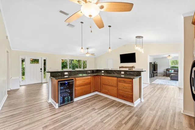 a kitchen with stainless steel appliances granite countertop a stove and a wooden floors