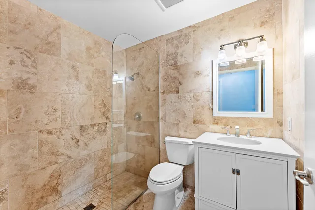 a bathroom with a sink toilet and shower