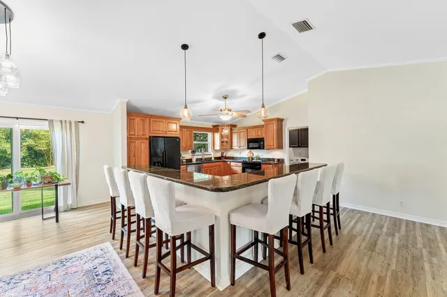 a dining room with furniture and wooden floor