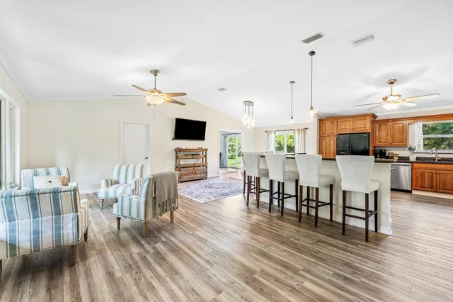 a view of a dining room with furniture and wooden floor