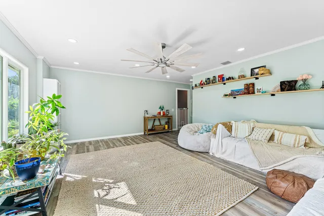 a bedroom with furniture and a potted plant