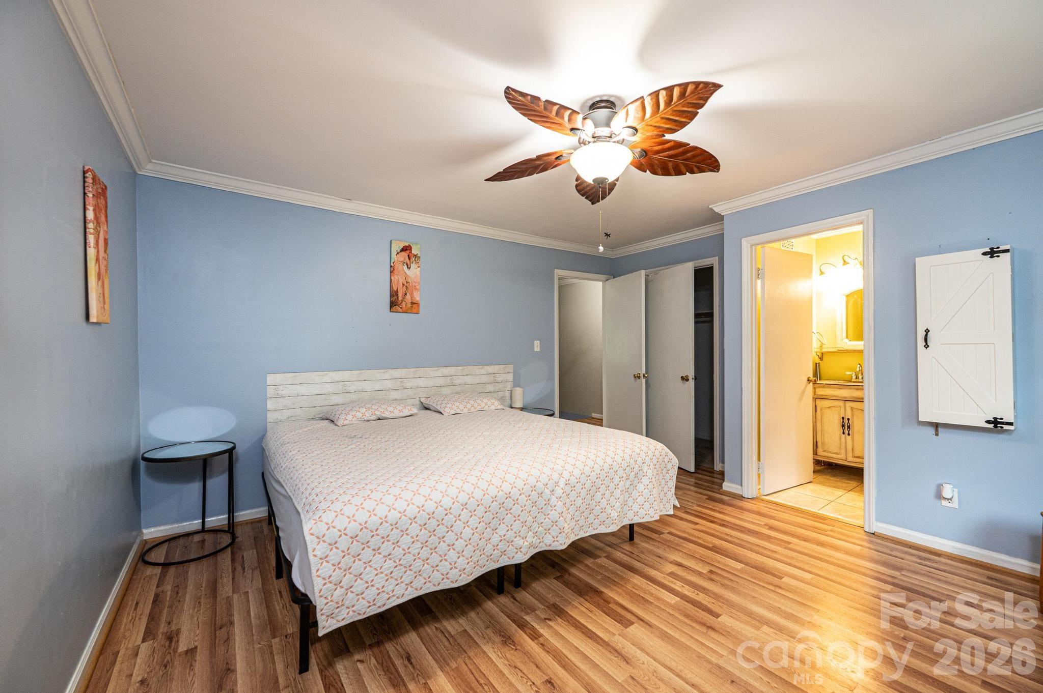 826 6th Street Northwest, Unit 4 Hickory, NC 28601 - Photo 17 of 25 a bedroom with a bed and a chandelier