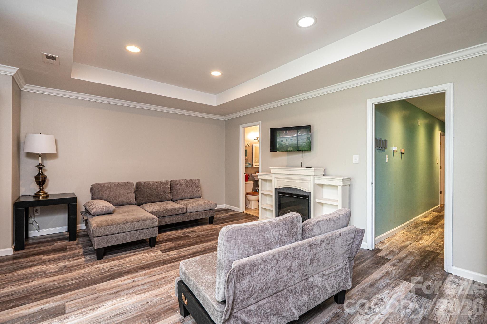 826 6th Street Northwest, Unit 4 Hickory, NC 28601 - Photo 19 of 25 a living room with furniture flat screen tv and a fireplace