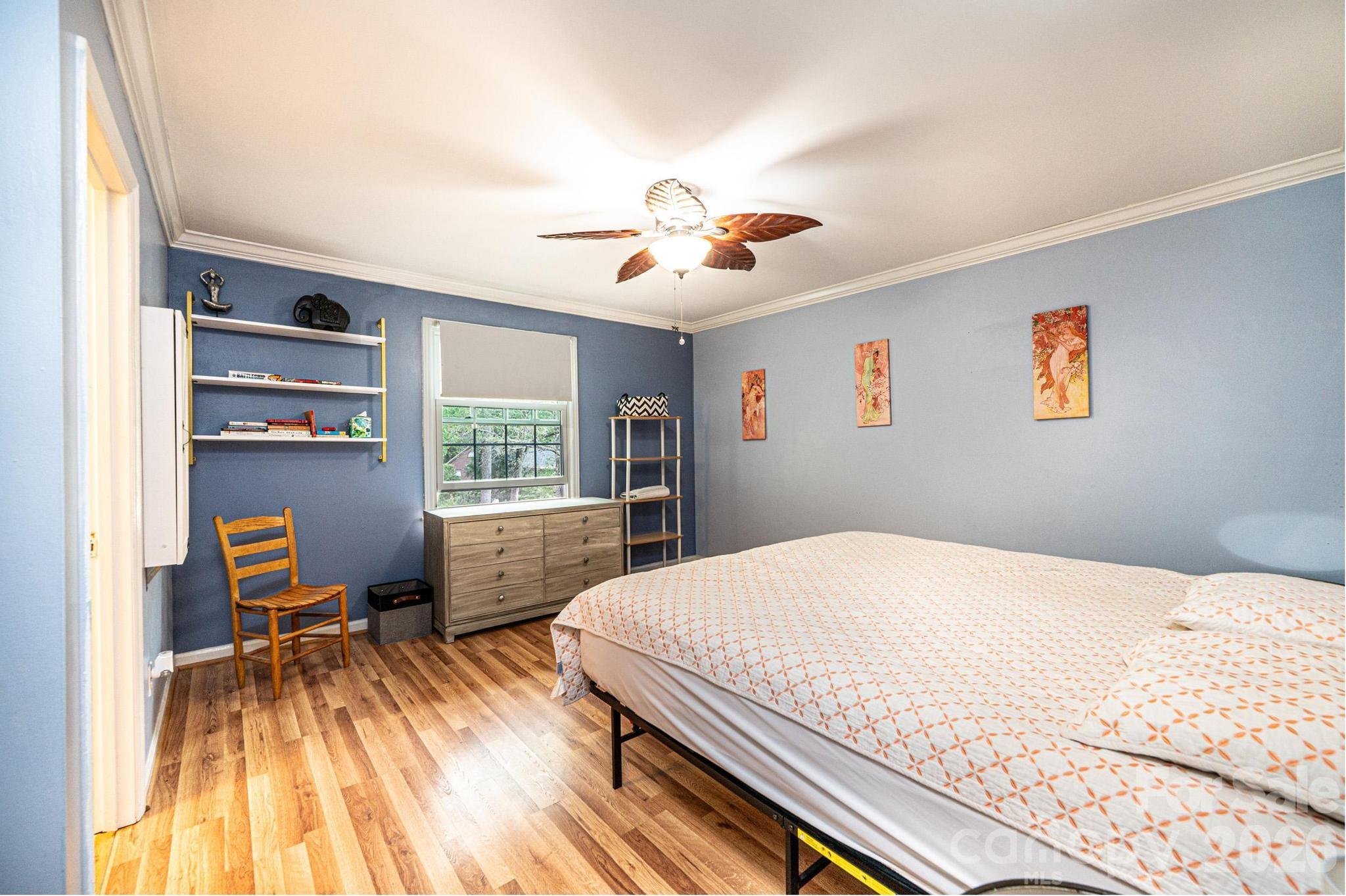 826 6th Street Northwest, Unit 4 Hickory, NC 28601 - Photo 22 of 25 a bedroom with a bed and a chandelier
