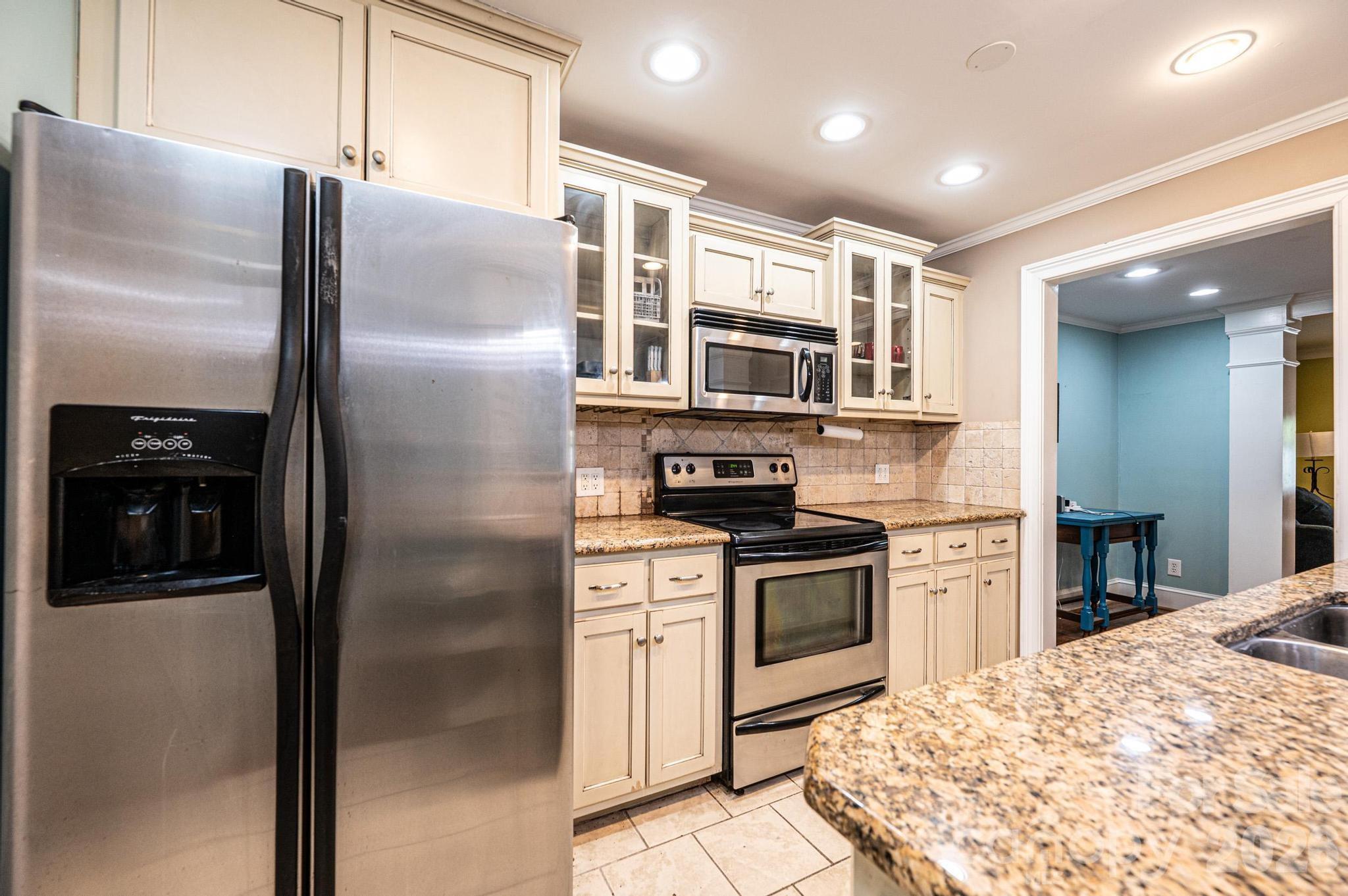 826 6th Street Northwest, Unit 4 Hickory, NC 28601 - Photo 6 of 25 a kitchen with stainless steel appliances granite countertop a refrigerator and a stove