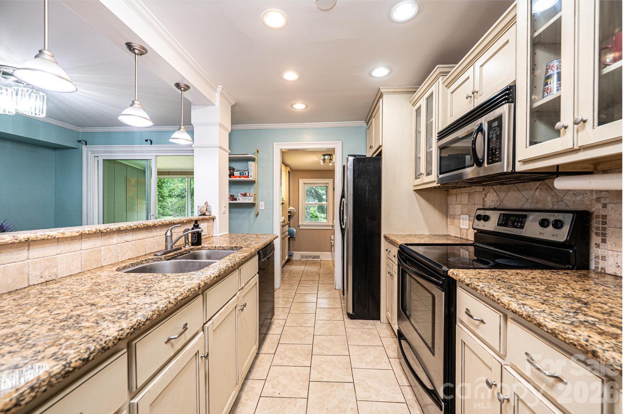 826 6th Street Northwest, Unit 4 Hickory, NC 28601 - Photo 7 of 25 a kitchen with granite countertop stainless steel appliances a sink stove and cabinets