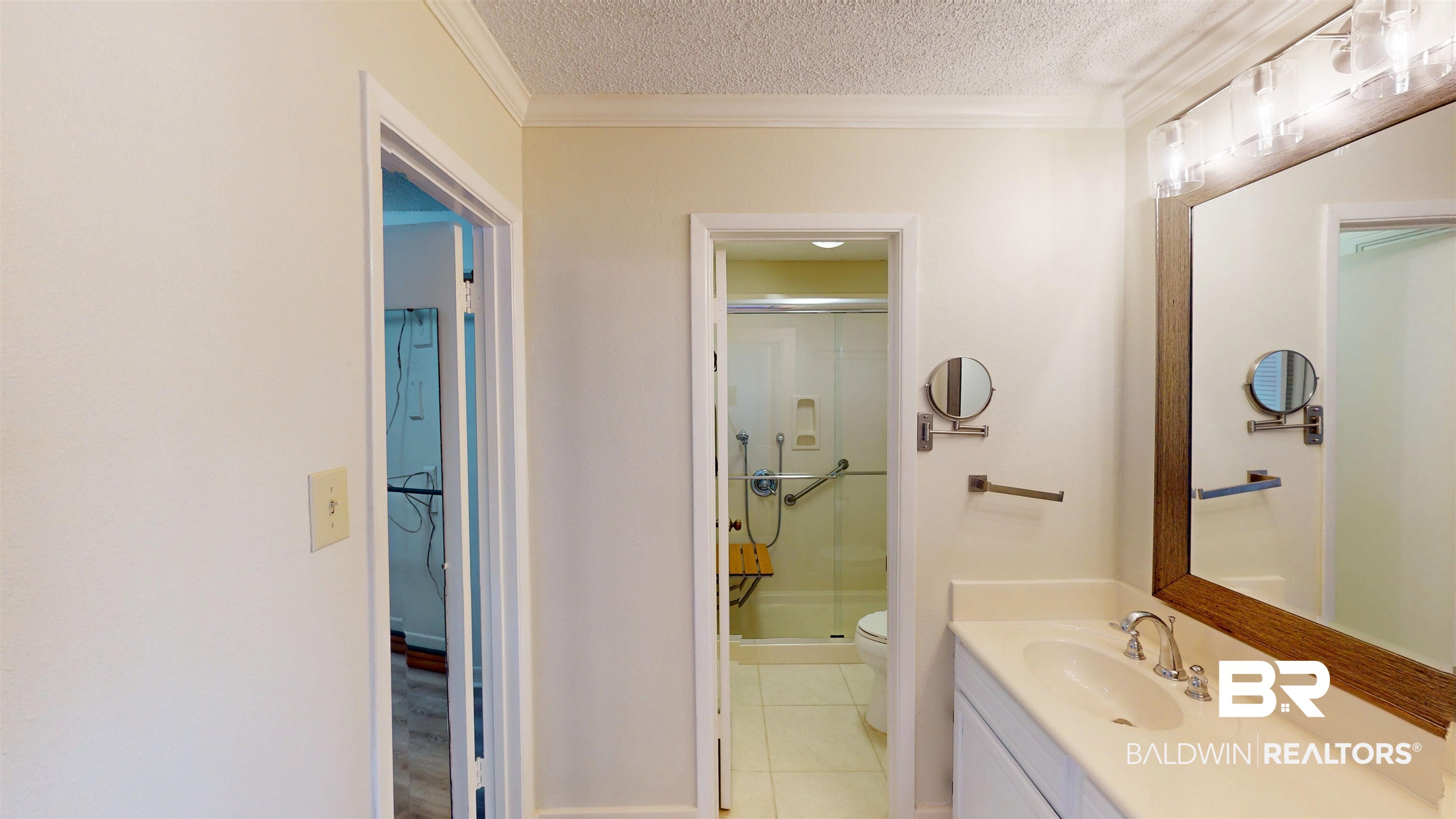 2901 Grant Street, Unit 902 Mobile, AL 36606 - Photo 15 of 35 Full bath with a shower stall, vanity, a textured ceiling, light tile patterned floors, and crown molding