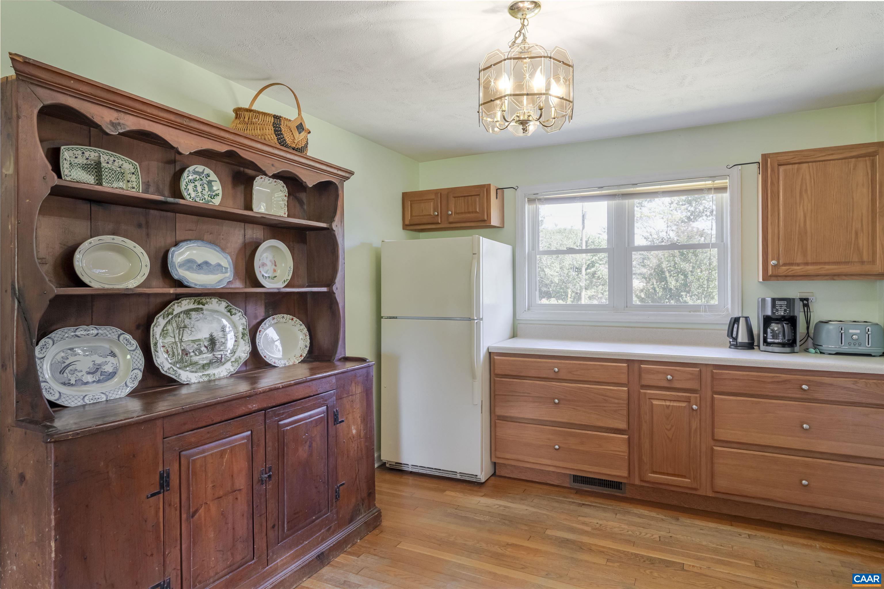 691 Old Roseland Road Roseland, VA 22967 - Photo 11 of 47 a kitchen with stainless steel appliances granite countertop a stove a refrigerator and a wooden cabinets
