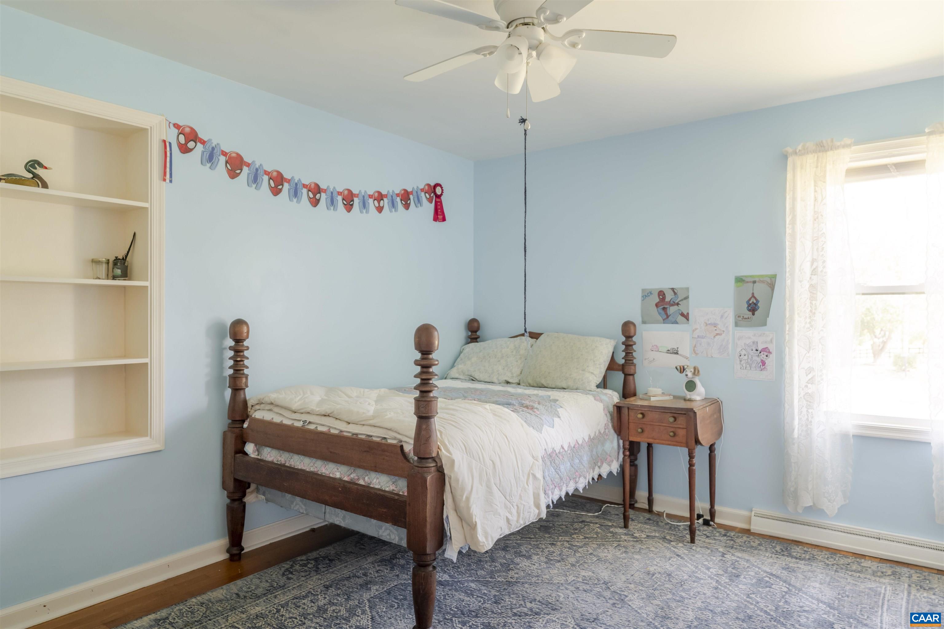 691 Old Roseland Road Roseland, VA 22967 - Photo 15 of 47 a bedroom with a bed and a chandelier