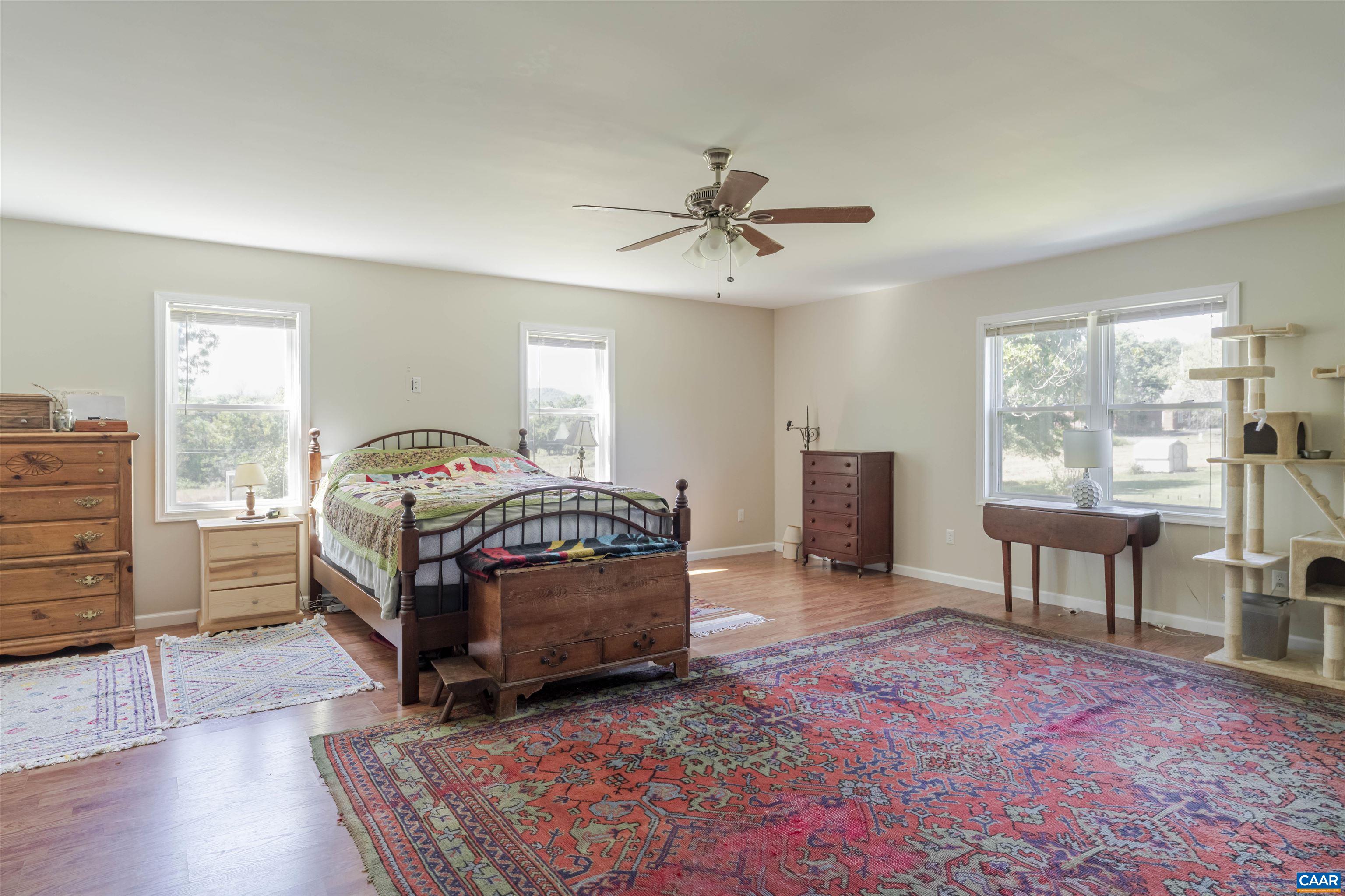 691 Old Roseland Road Roseland, VA 22967 - Photo 24 of 47 a bedroom with a bed and a chandelier