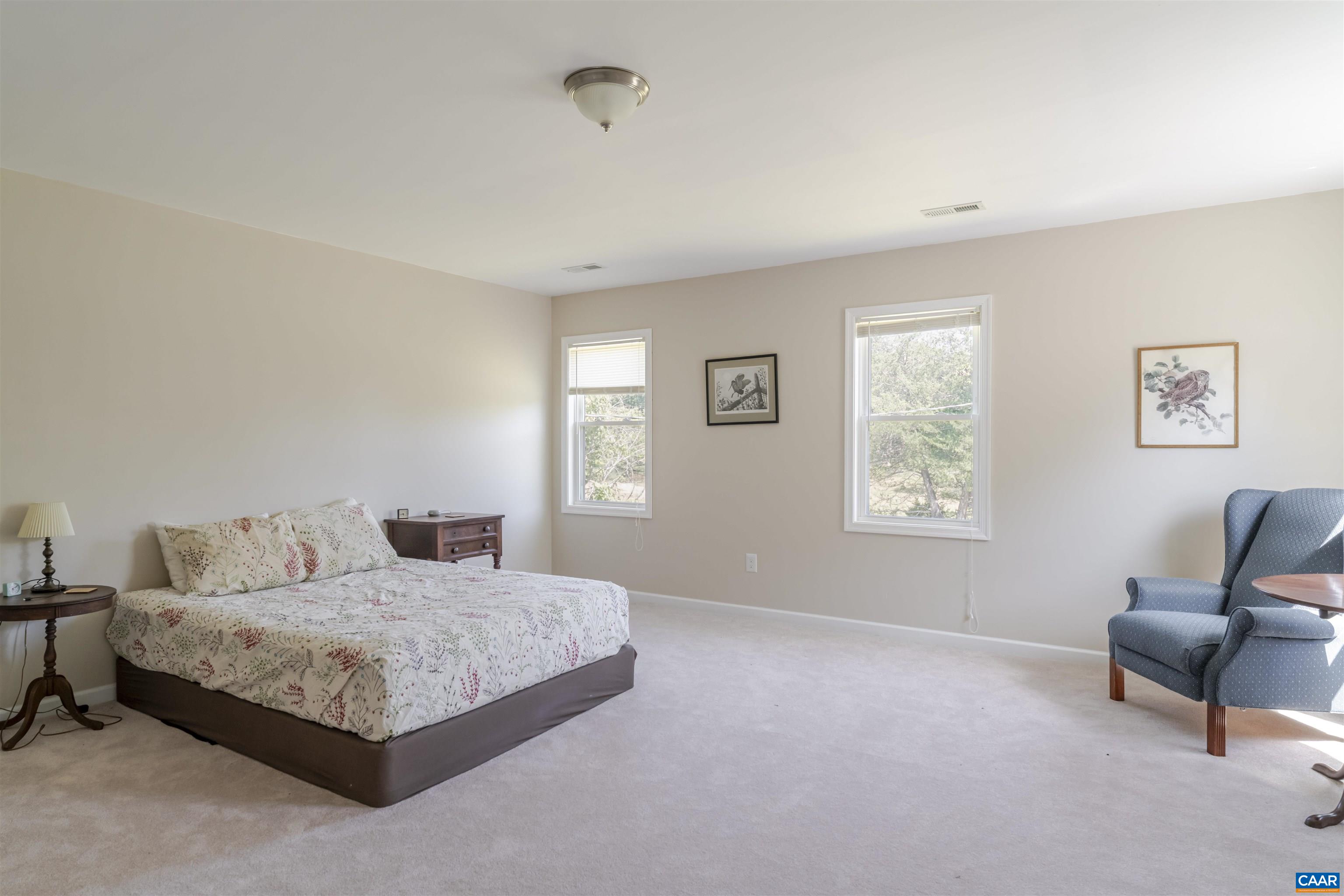691 Old Roseland Road Roseland, VA 22967 - Photo 33 of 47 a bedroom with a bed a couch and a window