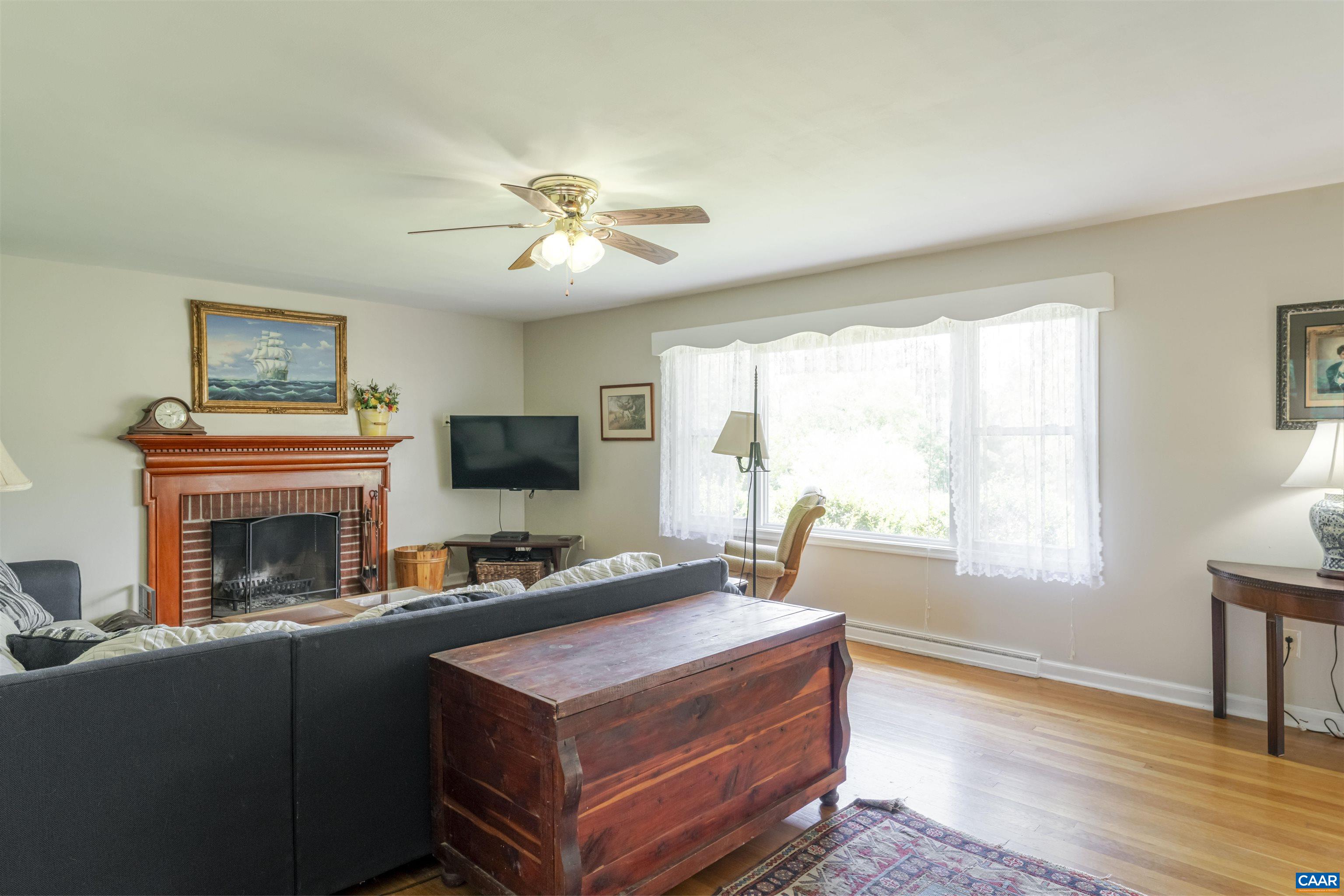 691 Old Roseland Road Roseland, VA 22967 - Photo 8 of 47 a living room with furniture a fireplace and a flat screen tv