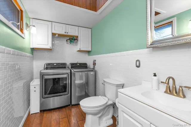 a bathroom with a sink toilet and a mirror