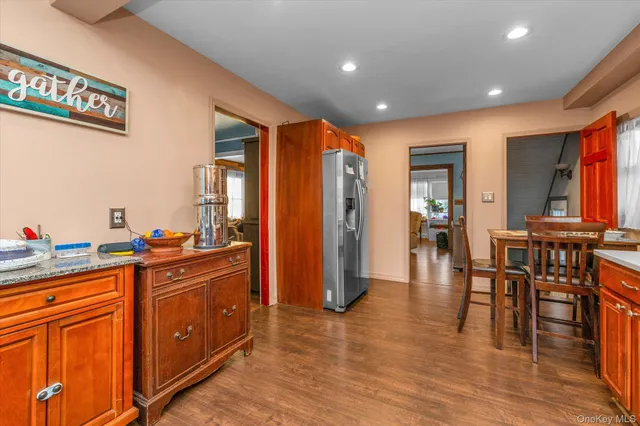 a very nice looking kitchen with granite countertop a large window and stainless steel appliances