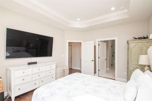 a bedroom with a bed and a flat screen tv in it