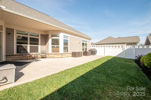 a front view of a house with a yard and outdoor seating