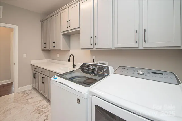 a view of a kitchen with sink and cabinets