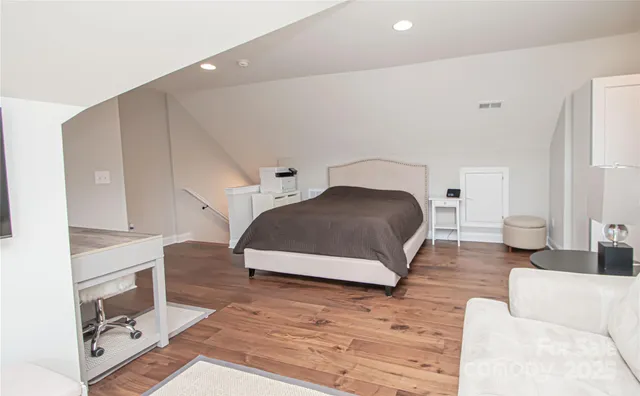 a bedroom with a bed lamp and a fireplace