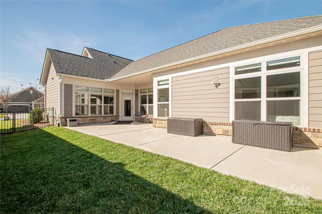 a front view of a house with a yard and seating space