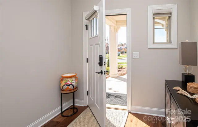 a view of an entryway with wooden floor and a window