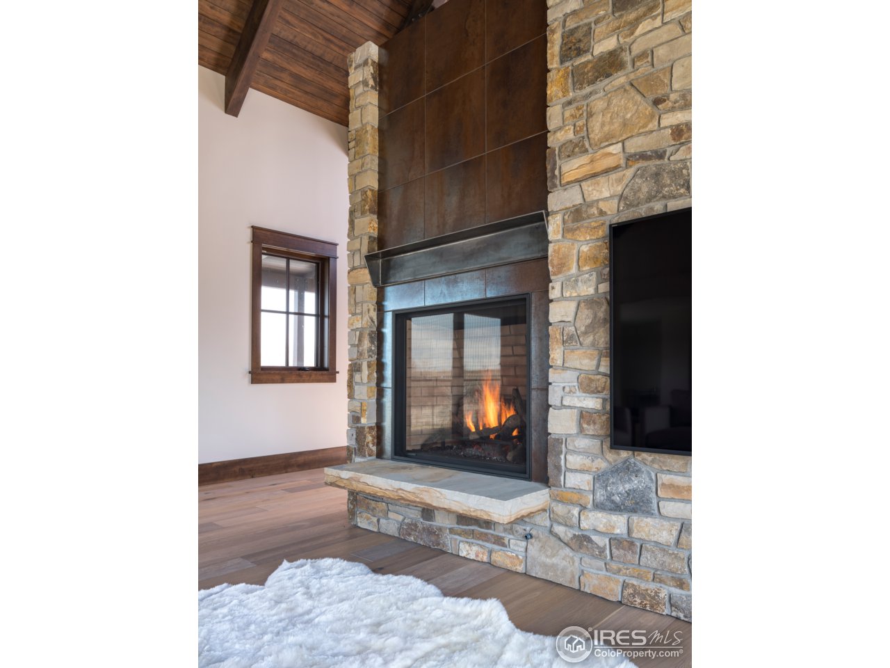 3840 Pleasant Ridge Road Boulder, CO 80301 - Photo 20 of 30 a living room with furniture and a fireplace