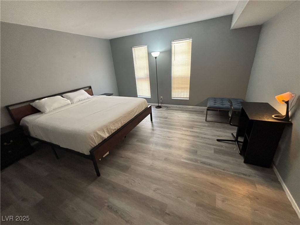 4640 Koval Lane, Unit 49A Las Vegas, NV 89109 - Photo 1 of 17 Bedroom featuring wood finished floors and baseboards