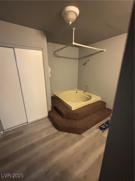 4640 Koval Lane, Unit 49A Las Vegas, NV 89109 - Photo 12 of 17 Bathroom with wood finished floors and a shower