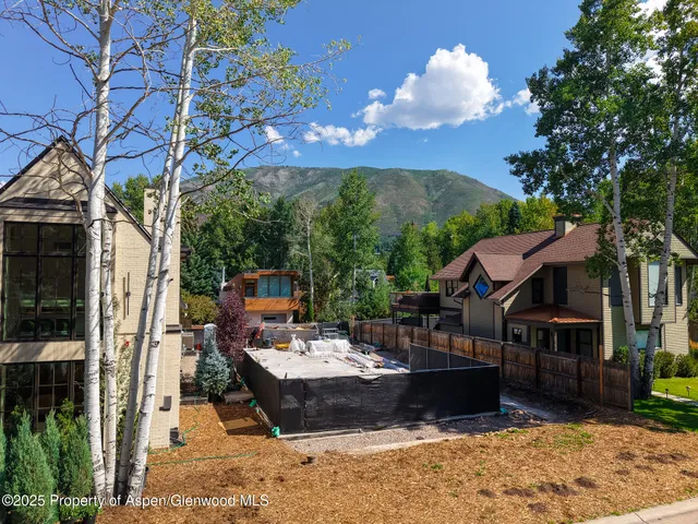 a view of a patio with couches table and chairs and potted plants