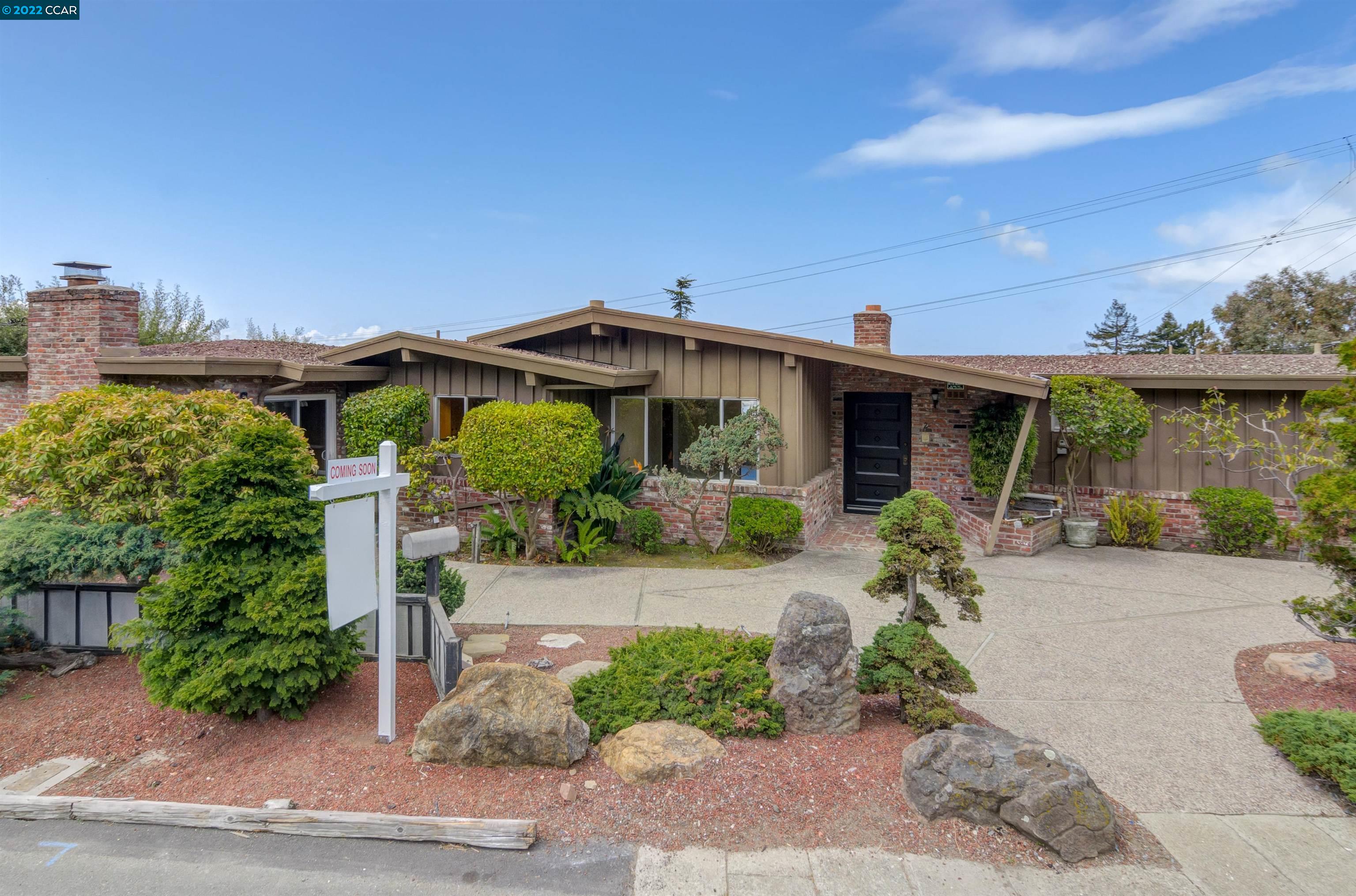 a front view of a house with garden