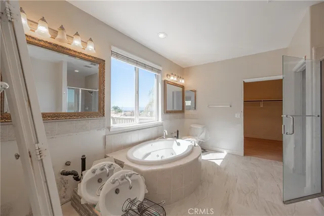a bathroom with a tub sink and mirror