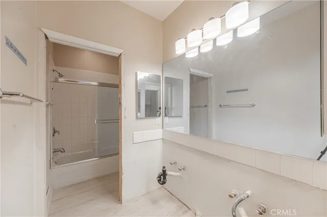 a bathroom with a shower and a mirror